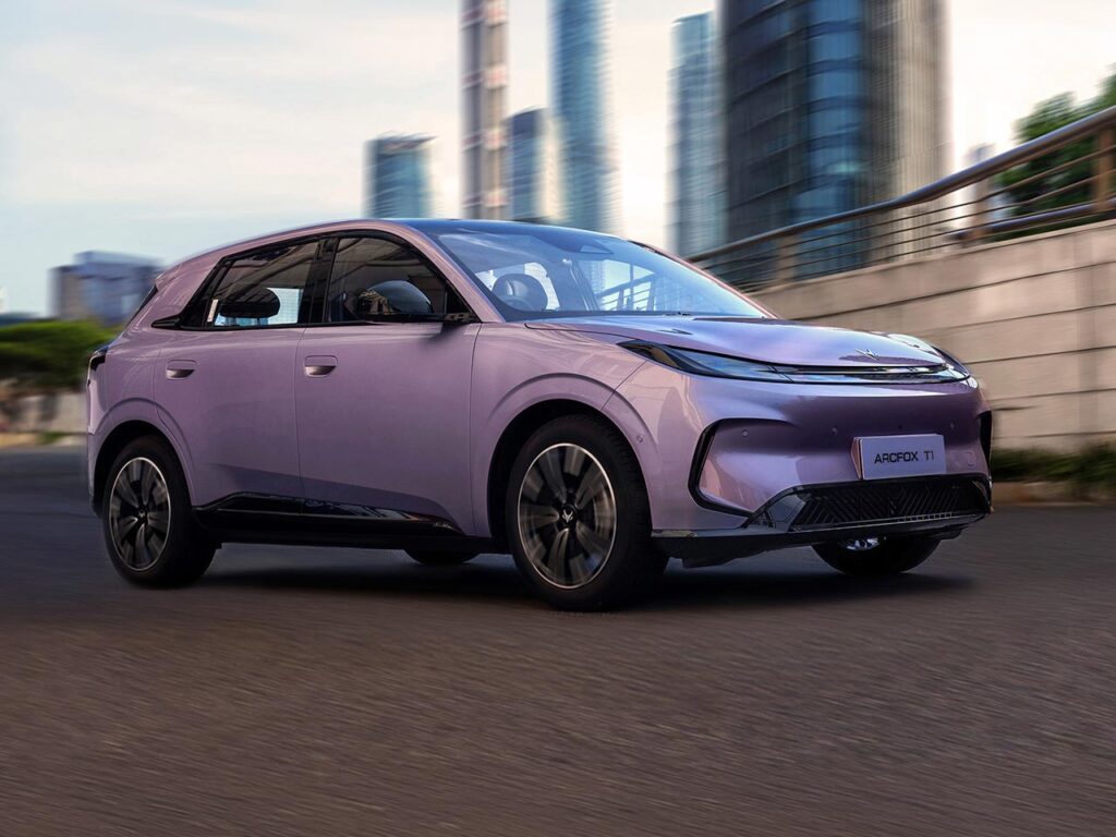 Front three quarter view of a purple ARCFOX T1 electric SUV driving on a city street