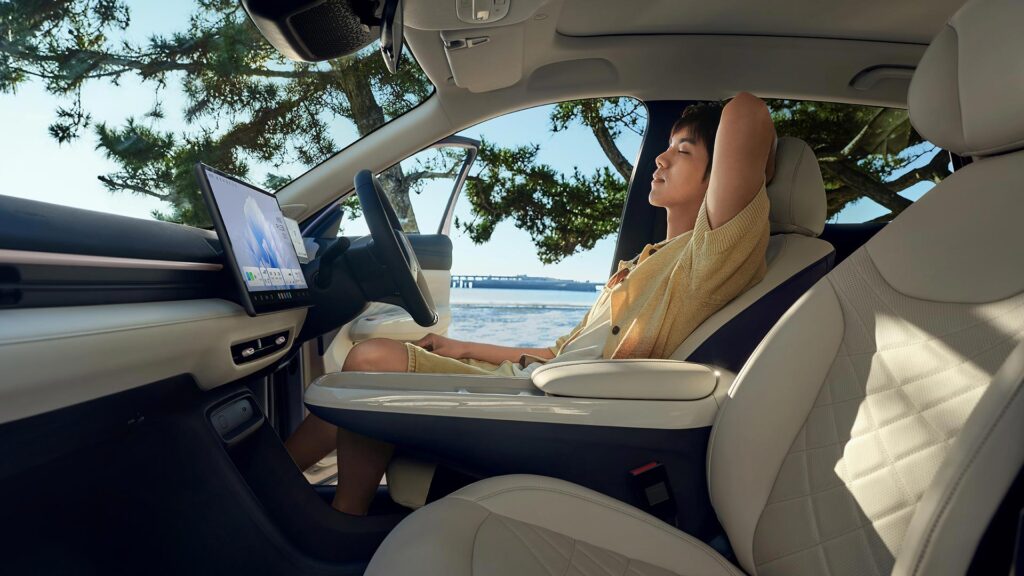 Man sitting and relaxing in the front seat of an all-electric ARCFOX T1 SUV