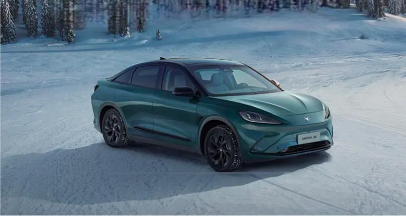 Front three quarter view of a green ARCFOX electric vehicle parked on the snow