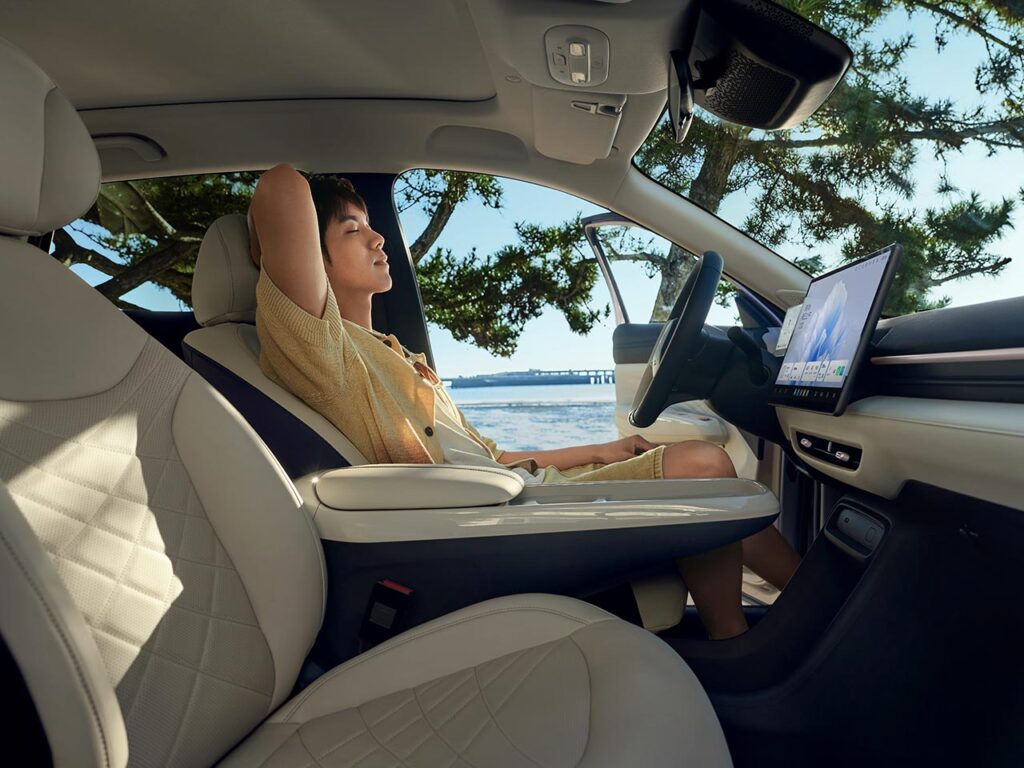 Man resting in the driver's seat of his all-electric ARCFOX T1 SUV