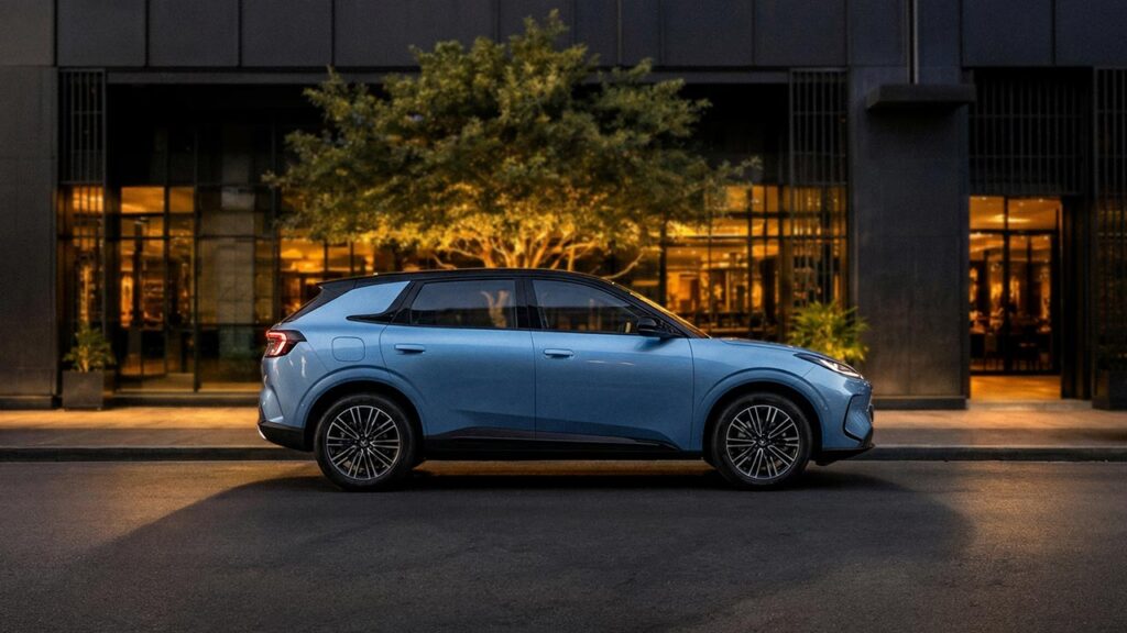 Side view of a blue ARCFOX T1 electric SUV parked in front of an apartment building at night