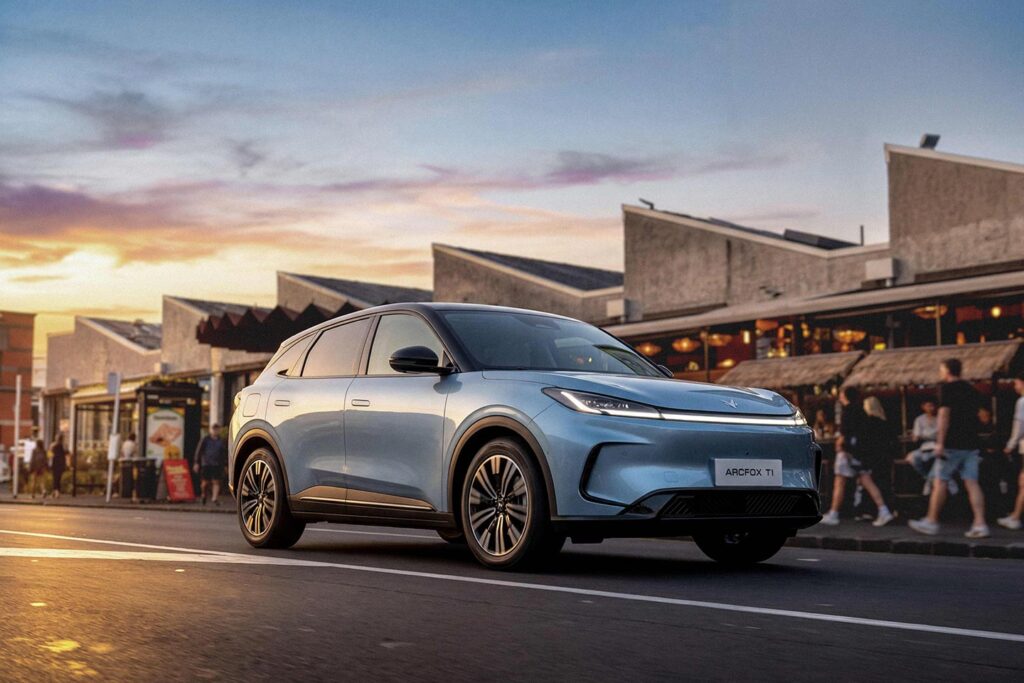 Front three quarter view of a blue ARCFOX T1 electric SUV driving on an Auckland street