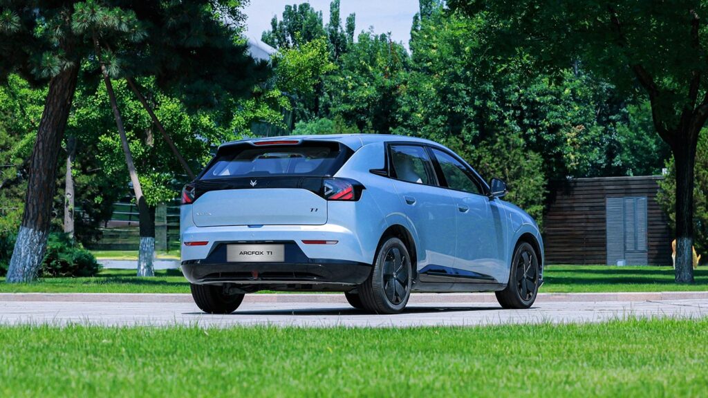 Rear three quarter view of a blue ARCFOX T1 electric SUV driving next to a park
